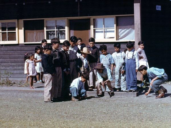 Boys playing marbles