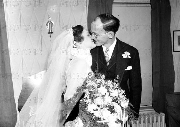 Bride and groom about to share a kiss ca. December 7