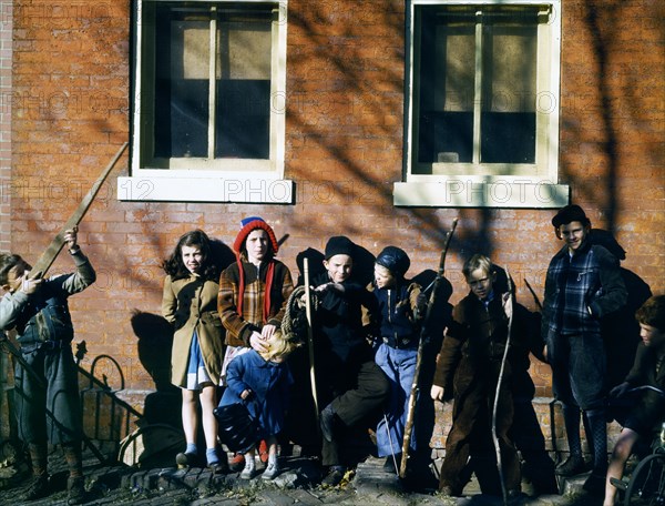 Children aiming sticks as guns