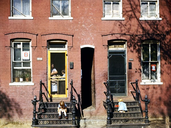 Children on row house steps