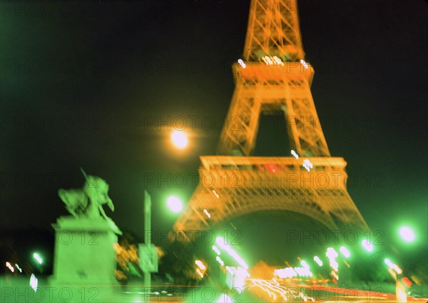 Early 1970s Blurred lights of Paris France at night at the Eifel Tower ca. 1974