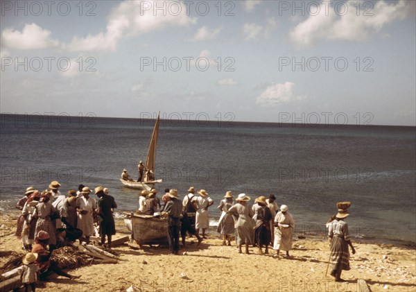 Housewives at the seashore waiting for the fishing boats to come in