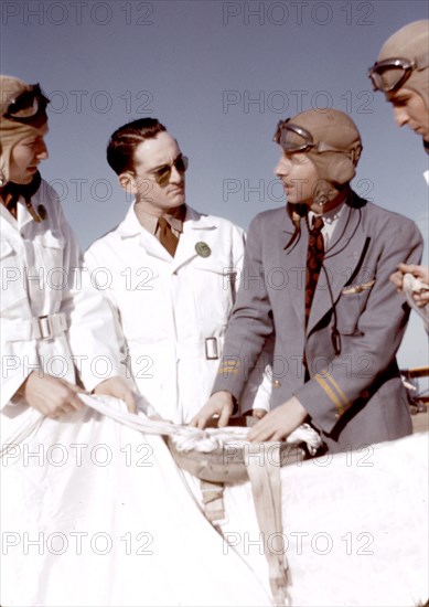 Instructor explaining the operation of a parachute to student pilots