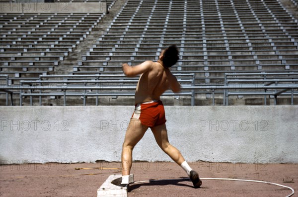 Male athlete shot put practice 1940s