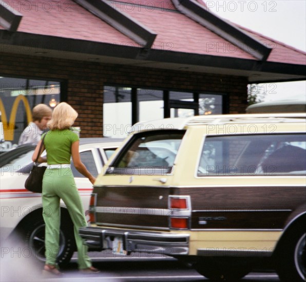 Man and woman entering their car after eating at McDonalds