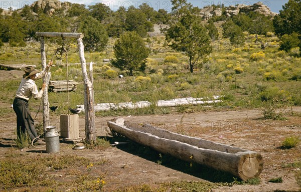 Manl drawing water from his well