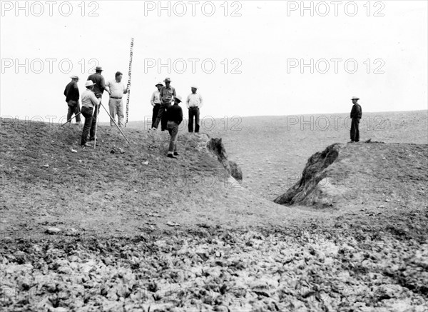 Men Working with Surveying Equipment