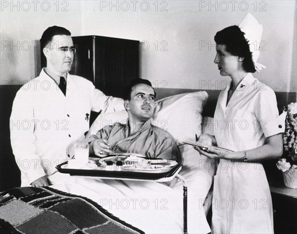 Military medical personnel with patient ca. mid 1900s