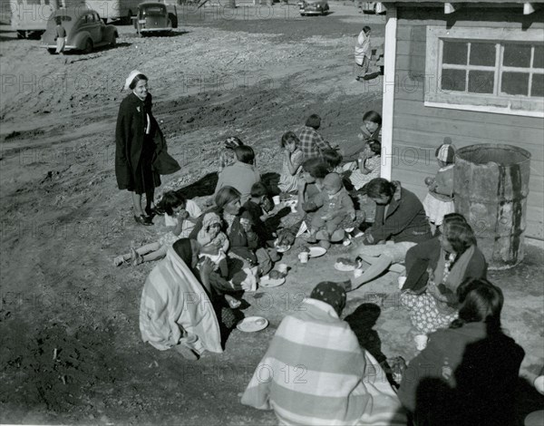 Native Americans Sit on Ground