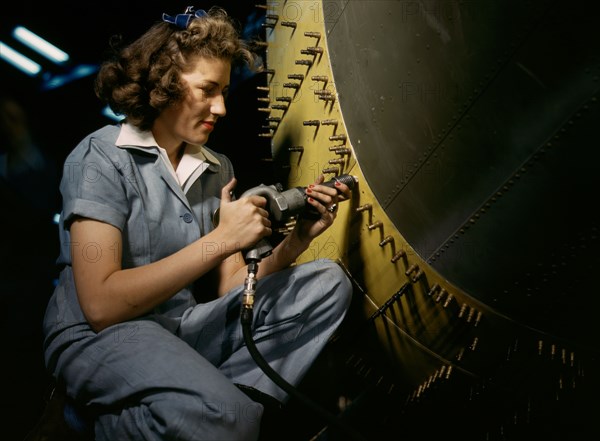 Riveter at work on Consolidated bomber