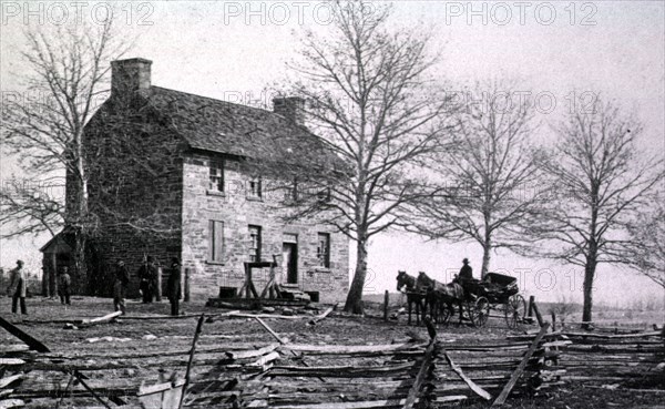 Several men stand outside of Mathew's house