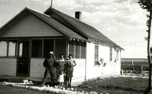 Family in front of house