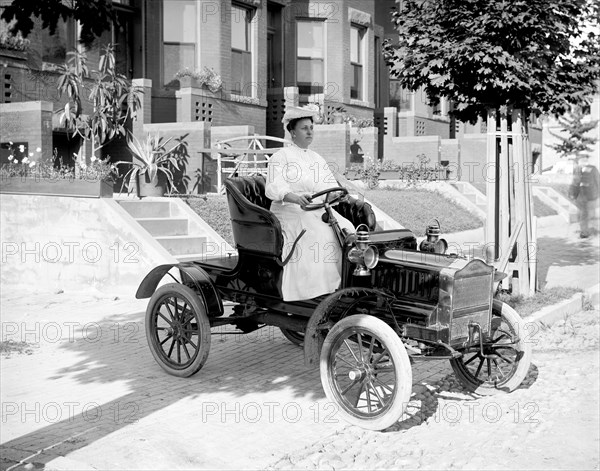 Woman driving an automobile in early 1900s