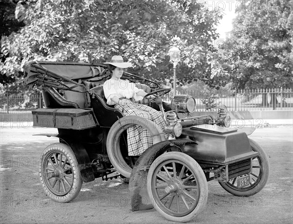 Woman driving an automobile in early 1900s