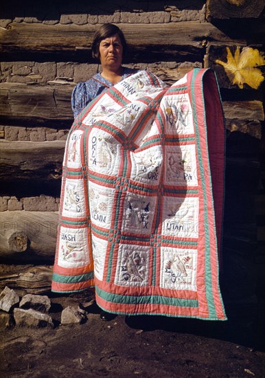 Woman quilter with state quilt which she made