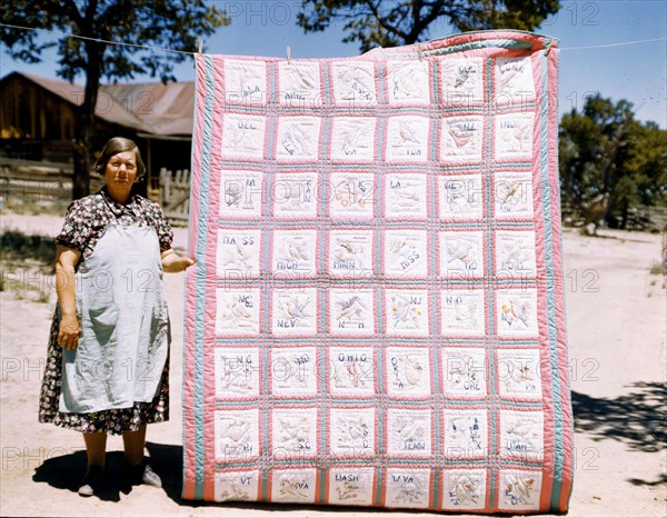 Woman quilter with state quilt which she made