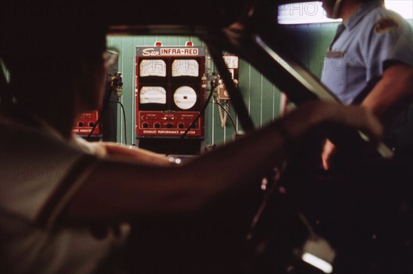 Woman Sits in Her Car Watching the Readings