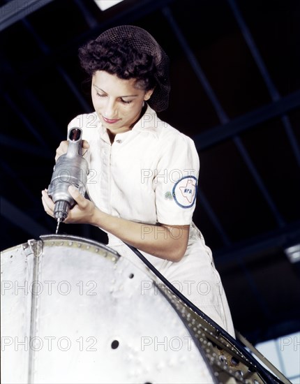 Woman worker riveting as part of her NYA training