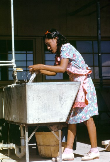 Young woman at the community laundry on Saturday afternoon