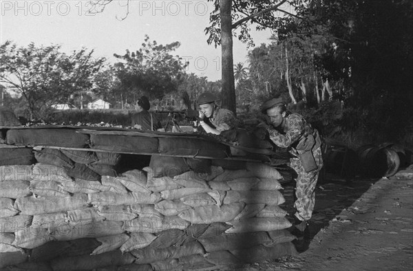 Dutch Soldiers in position behind a reinforcement with sandbags in Indonesia, Dutch East Indies ca. 1947