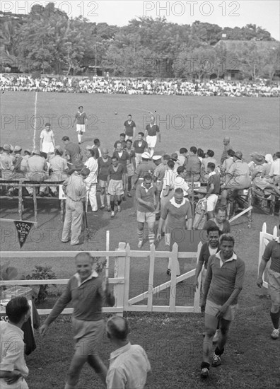 Players leave field after soccer game - August 31, 1948 Location Indonesia, Medan, Dutch East Indies, Sumatra