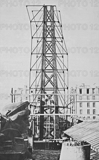 Statue of Liberty History - Scaffolding for the assemblage of the Statue of Liberty, of which the head is shown at left, in Paris ca. 1883