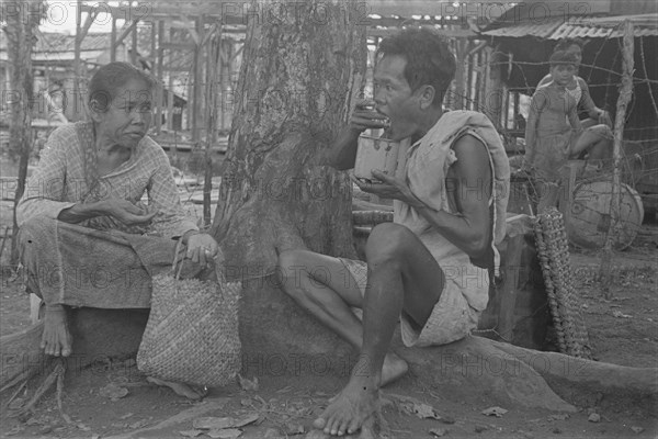 Man and a woman eat; Date January 1947; Location Indonesia, Dutch East Indies, Palembang, Sumatra