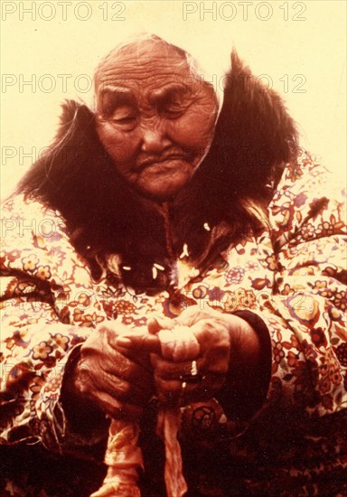 Early 1970s - Elderly Eskimo woman trimming seal intestines