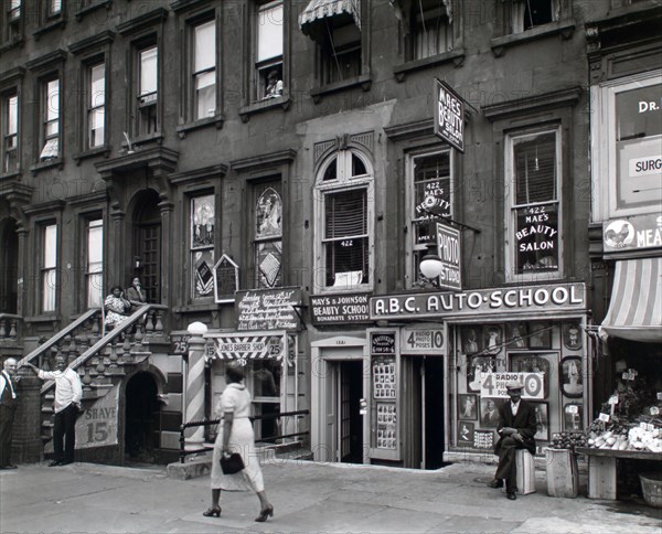 Woman walking in Harlem New York 422-424 Lenox Avenue, Manhattan ca. 1938