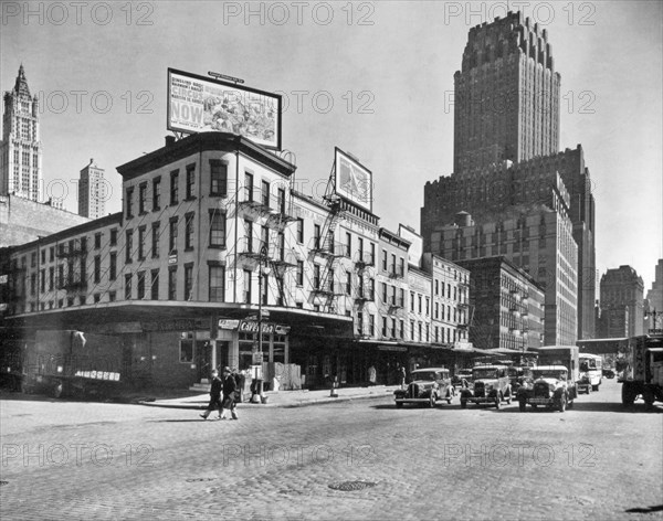 Billboards top buildings at the corner of Warren and West Sts., cars stopped in street, Telephone and World Telegram building beyond at r. West Street Row: V, between Warren & Murray Streets, Manhattan ca. 1936
