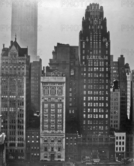 View from across the Bryant Park, incl. Scientific American, American Radiator Bldgs., corner of the library; Empire State Building beyond. 40th Street between Fifth and Sixth Avenues, Manhattan ca. 1935