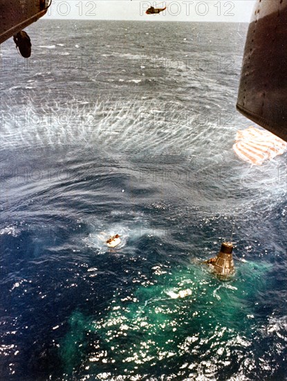 (16 May 1963) A U.S. Navy frogman, deployed from the hovering helicopter, swims next to the spacecraft and makes contact with astronaut L. Gordon Cooper Jr. inside, as his fellow team members bring up the floatation gear to be attached to the spacecraft.