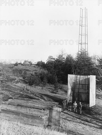 Dr. Robert H. Goddard's tower and shelter at the Army artillery range at Camp Devens, in Ayer, Massachusetts in the winter of 1929-1930. Goddard originally began testing rockets on his aunt's farm in Auburn, Massachusetts until the local police, fire department and townspeople became concerned about the noise and menace to the public the rockets created.