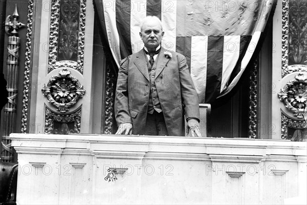 Photo shows Speaker of the House James Beauchamp 'Champ' Clark standing at the rostrum in the House of Representatives chamber, United States Capitol ca. 1911