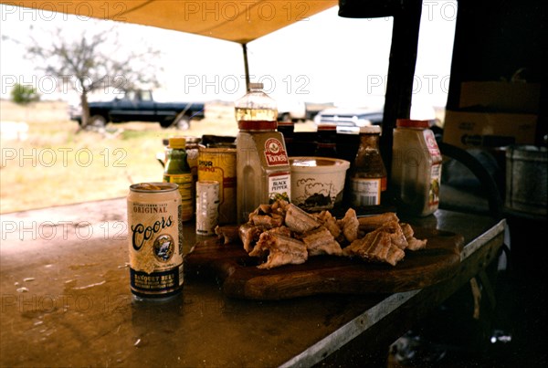 Authentic American Cowboys: Can of Coors beer sitting next to chopped up rattlesnake before being cooked