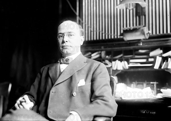 Ralph Edmunds, seated at desk 12 11 1908