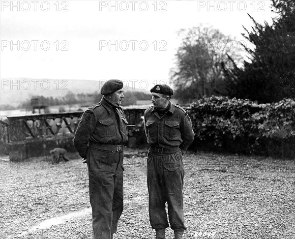 Lt. Col. Vaughan, Commander of a Commando Depot , confers with his second in command, Major Peter Cookcraft, on the day's schedule for a Ranger Unit. Scotland, February 12, 1943. Lt.. Col. C.E. Vaughan of 29th Ranger Battalion., Spean Bridge, Scotland.