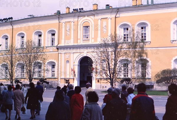 Pedestrians outside of a building on a cool spring day in a major city in Russia in late 1970s (1978)