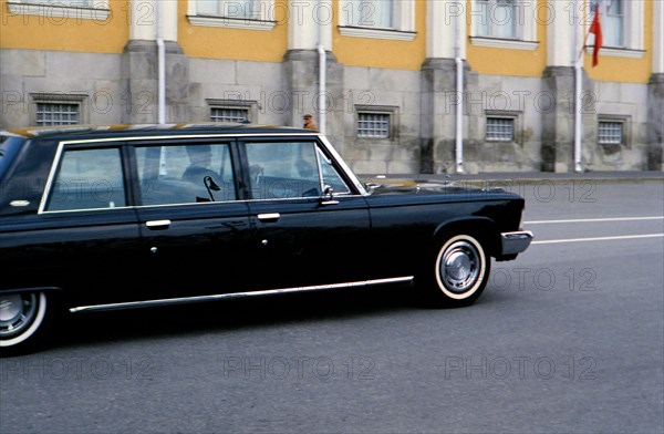 Luxury automobile driving down street in Russian city ca. 1970s (1978)