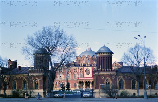 Soviet Buildings and Architecture - a building adorned with a large banner of Vladimir Lenin in a large city in Russia in the late 1970s (1978)