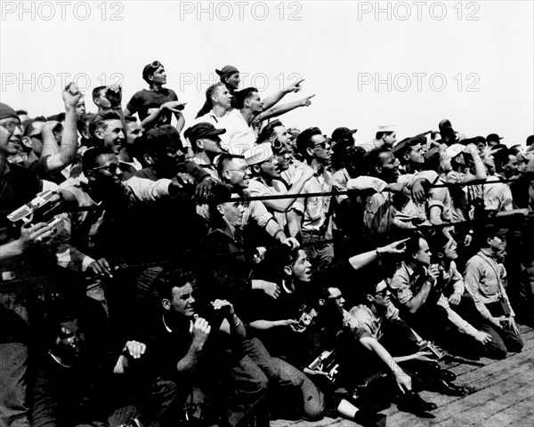 (5 May 1961) Crew members of the U.S. Navy Carrier Champlain cheer and take pictures of the arrival of the first Project Mercury pilot to fly a suborbital flight, astronaut Alan B. Shepard Jr.