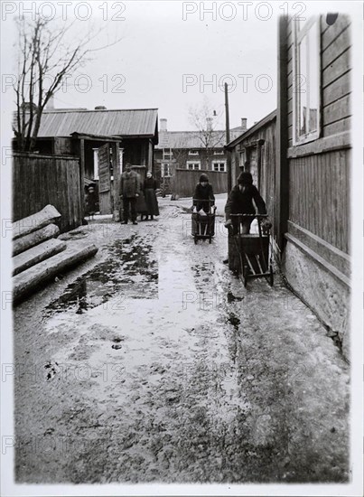 Two bobsleighers navigating the wet streets