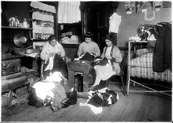 Family finishing pants. None of them spoke English. New York City, March 1912