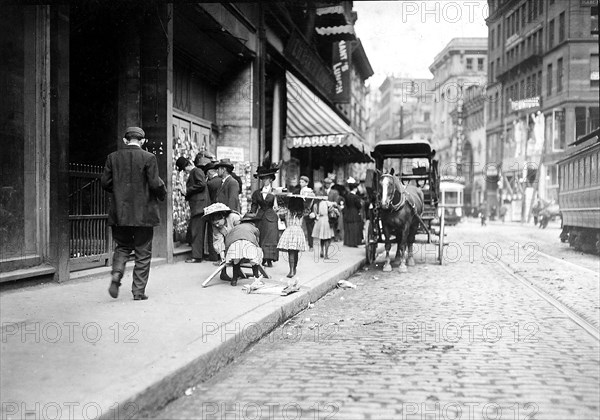 Little girl woodpickers making up a load. Boston, Mass, October 1909