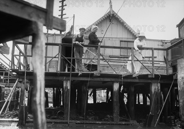 Men fishing off the front porch of a house in Broad Channel, Queens ca. 1910-1915