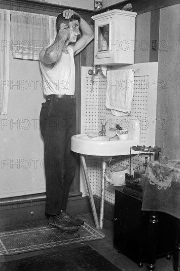 Man shaving in a home in Broad Channel, Queens ca. 1910-1915