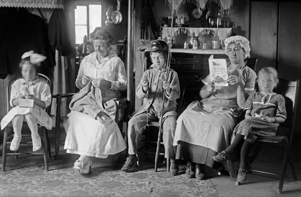 Family seated in a living room in a house in Broad Channel, Queens ca. 1910-1915