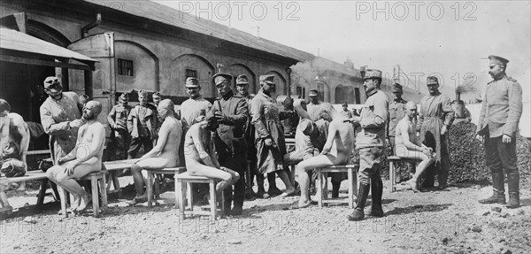 German soldiers having their heads shaved during World War I ca. 1914-1915