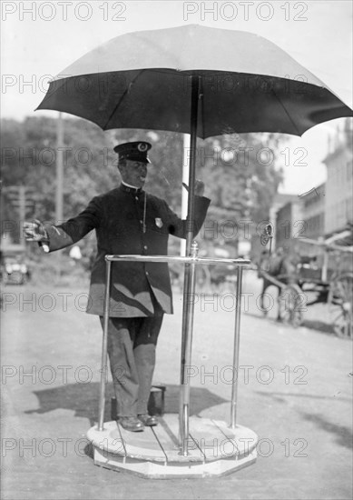 Officer Freeborn Coggeshall of Newport, Rhode Island standing on a platform he invented to use while directing traffic ca. 1910-1915