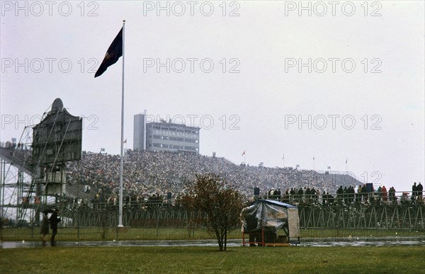View of crowd in stands and parked cars at Beaver Stadium for Penn State football game (December 1962)